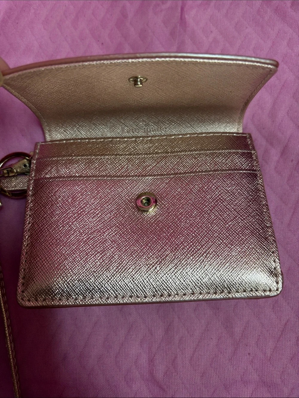 kate spade metallic rose gold wristlet card holder with tassel